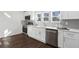 Modern kitchen featuring stainless steel appliances, white cabinetry, and sleek countertops at 1721 Hortense Nw Pl, Atlanta, GA 30318