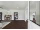 Open living room view from doorway, featuring a stone fireplace, dark floors, and stylish shelving units at 1721 Hortense Nw Pl, Atlanta, GA 30318