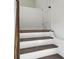 A view of the staircase with dark wood treads and white risers and handrail at 1721 Hortense Nw Pl, Atlanta, GA 30318