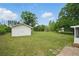 Expansive backyard featuring a storage shed and mature trees, perfect for outdoor activities and relaxation at 46 Forkwood Cir, Hiram, GA 30141