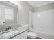 Bathroom featuring granite countertop vanity, tub, and tiled walls at 46 Forkwood Cir, Hiram, GA 30141