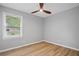 Bright bedroom with wood-look flooring, a modern ceiling fan, and fresh paint at 46 Forkwood Cir, Hiram, GA 30141