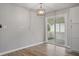 Bright dining area with a modern chandelier, sliding glass doors to screened porch, and wood-look flooring at 46 Forkwood Cir, Hiram, GA 30141