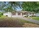 A side view of a single-story home featuring a long driveway and detached garage at 46 Forkwood Cir, Hiram, GA 30141