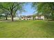 Single-story home with a neatly maintained lawn, framed by lush green trees at 46 Forkwood Cir, Hiram, GA 30141