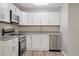 Updated kitchen featuring white cabinets, stainless steel appliances, and sleek countertops at 46 Forkwood Cir, Hiram, GA 30141