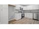 Modern kitchen featuring white cabinets, stainless steel appliances, and stone countertops at 46 Forkwood Cir, Hiram, GA 30141