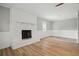 Living room with fireplace, wood-look flooring, fresh paint, and white wainscoting at 46 Forkwood Cir, Hiram, GA 30141
