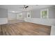 Open living room with wood-look flooring and ample natural light from the numerous windows at 46 Forkwood Cir, Hiram, GA 30141