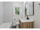 Bathroom boasts new vanity, hardware, tile floor, mirror, toilet and shower tiling at 2590 Eastwood Dr, Decatur, GA 30032