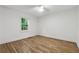 Bright bedroom featuring hardwood floors, neutral walls, and window offering outdoor views at 2590 Eastwood Dr, Decatur, GA 30032