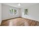 Bedroom features hardwood floors, a ceiling fan, and new windows offering natural light at 2590 Eastwood Dr, Decatur, GA 30032