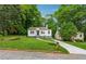 Traditional-style home with well-maintained lawn, landscaping, and mature trees at 2590 Eastwood Dr, Decatur, GA 30032