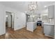 Modern kitchen with white subway tile backsplash, stainless appliances, gray cabinets, hardwood floors, and an island at 2590 Eastwood Dr, Decatur, GA 30032
