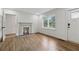 Bright living room with fireplace, hardwood floors, and a front door allowing for natural light at 2590 Eastwood Dr, Decatur, GA 30032