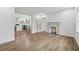 Open-concept living room features a fireplace, hardwood floors, white walls, and an open view into the kitchen at 2590 Eastwood Dr, Decatur, GA 30032
