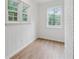 Small bright room features wainscotting, vinyl floors, white walls, and three windows at 2590 Eastwood Dr, Decatur, GA 30032