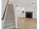 Living area with hardwood floors, staircase, modern fireplace and view to kitchen at 2864 Vining Ridge Ter, Decatur, GA 30034