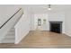 Spacious living area with hardwood floors, a fireplace, and access to the staircase at 2864 Vining Ridge Ter, Decatur, GA 30034