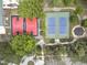 This aerial view shows a basketball court and tennis courts among a lush community at 3253 Cates Ne Ave, Brookhaven, GA 30319