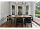 Dining room features a modern table, stylish chairs, and natural light from large windows at 3253 Cates Ne Ave, Brookhaven, GA 30319