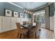 Elegant dining room with a modern chandelier, hardwood floors, and seating for six at 3253 Cates Ne Ave, Brookhaven, GA 30319