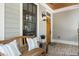 Inviting front porch with a wooden bench, brick flooring, and a stylish wooden door with glass accents at 3253 Cates Ne Ave, Brookhaven, GA 30319