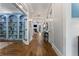 Elegant hallway with hardwood floors, white trim, and a view of the living room with a fireplace at 3253 Cates Ne Ave, Brookhaven, GA 30319