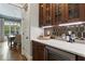 Chic kitchen featuring a counter with stylish backsplash, wooden cabinets and a view into the dining room at 3253 Cates Ne Ave, Brookhaven, GA 30319