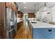 Kitchen featuring island, stainless steel refrigerator, and wood floors at 3253 Cates Ne Ave, Brookhaven, GA 30319