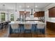 Kitchen boasts large island with seating, stainless steel appliances, and stylish pendant lighting at 3253 Cates Ne Ave, Brookhaven, GA 30319
