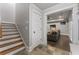 Finished basement with stairs leading down to the open living room, dark wood floors, and ample light at 3253 Cates Ne Ave, Brookhaven, GA 30319