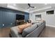 Modern living room with a plush gray sofa, sleek ceiling fan, and a stylish entertainment center at 3253 Cates Ne Ave, Brookhaven, GA 30319