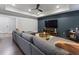 Open-concept living room with a large sectional sofa, entertainment center, and natural light at 3253 Cates Ne Ave, Brookhaven, GA 30319