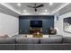 Relaxing living room with a sectional sofa, modern fan, and a large television for comfortable viewing at 3253 Cates Ne Ave, Brookhaven, GA 30319