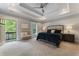 A spacious main bedroom with an outdoor balcony, tray ceiling and plush bedding at 3253 Cates Ne Ave, Brookhaven, GA 30319