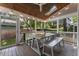 Relaxing covered patio with ceiling fan, skylight, and a rustic dining set at 3253 Cates Ne Ave, Brookhaven, GA 30319
