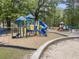 A colorful playground with multiple play structures, slides, and a sandbox is nestled among mature trees at 3253 Cates Ne Ave, Brookhaven, GA 30319
