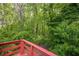 View from the back deck reveals a wooded lot with mature trees at 3349 Old Atlanta Rd, Suwanee, GA 30024