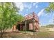 Back of house shows second story deck, first story patio and basement access at 3349 Old Atlanta Rd, Suwanee, GA 30024
