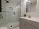 Modern bathroom featuring a glass shower with sleek fixtures and gray vanity with white countertop at 3349 Old Atlanta Rd, Suwanee, GA 30024