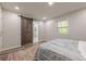This bedroom has a barn door, a window, a closet and is carpeted at 3349 Old Atlanta Rd, Suwanee, GA 30024