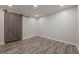 Bedroom featuring wood floors, recessed lighting and a sliding barn door for closet at 3349 Old Atlanta Rd, Suwanee, GA 30024