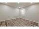 Bright bedroom boasts stylish wood floors, neutral walls, recessed lighting, and a window at 3349 Old Atlanta Rd, Suwanee, GA 30024