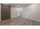 Empty bedroom that is carpeted, has a barn door and closet at 3349 Old Atlanta Rd, Suwanee, GA 30024