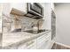 Modern kitchen with granite countertops, white cabinets, stainless steel appliances, and tiled backsplash at 3349 Old Atlanta Rd, Suwanee, GA 30024