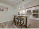 Modern kitchen features white cabinetry, stainless appliances, and a decorative island with seating at 3349 Old Atlanta Rd, Suwanee, GA 30024
