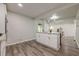 Stylish kitchen island features white cabinets, granite countertop, and a view of the living area at 3349 Old Atlanta Rd, Suwanee, GA 30024
