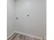 Small laundry room with wood look floors and utility hookups at 3349 Old Atlanta Rd, Suwanee, GA 30024