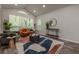 Bright living room features large windows, vaulted ceilings, hardwood floors, and stylish furnishings at 3349 Old Atlanta Rd, Suwanee, GA 30024